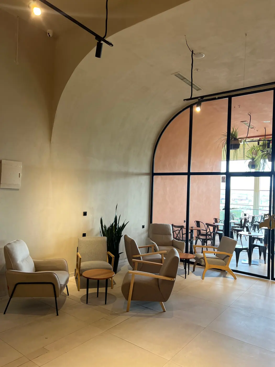 Cosy lounge seating under the arched window at Tai Sweets Prishtina Mall