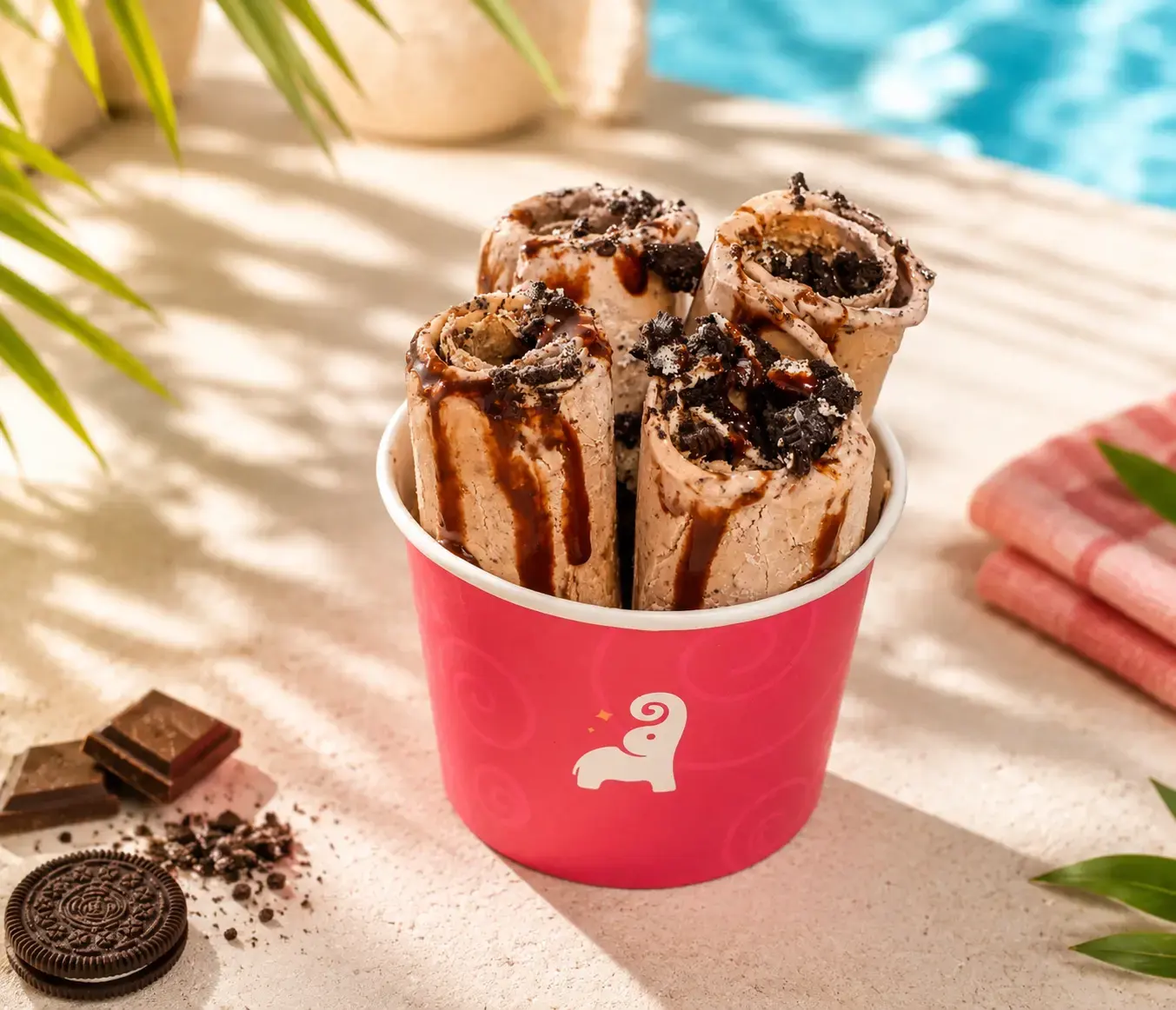 Tai Sweets rolled ice cream with chocolate sauce and cookie pieces in a pink Tai Sweets cup